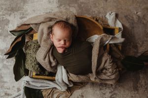 newborn session in Centralia, IL studio session, baby boy, foliage, wrapped