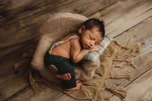 newborn session in Centralia, IL studio session, baby boy, newborn prop, newborn chair, advanced posing foliage, wrapped