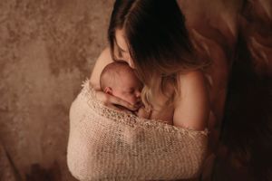 mother and son newborn wrapped boho session